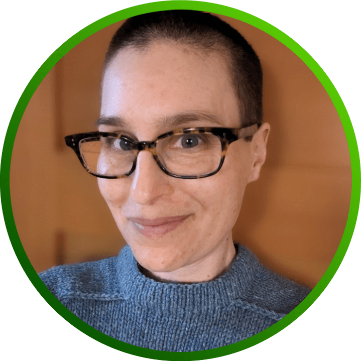 Portrait photo of Lea Kissner, CISO of LinkedIn, wearing a grey-blue sweater and glasses.