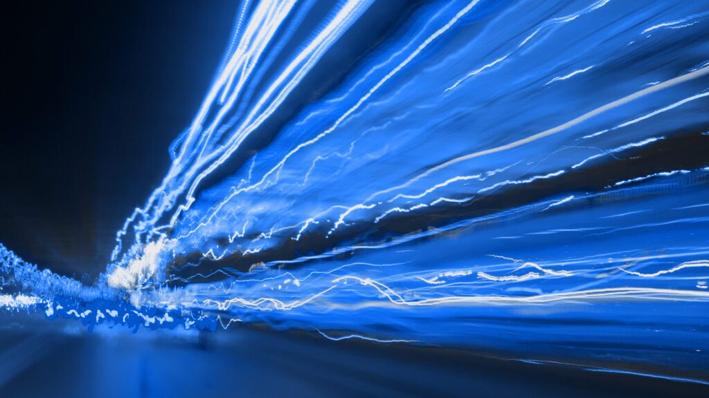 streaming lights that meet at the vanishing point to indicate the data that is communicated via telecommunications companies and their need to comply with the Telecommunications Security Act in the United Kingdom.