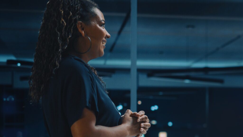 A woman presents to symbolize leadership in cybersecurity