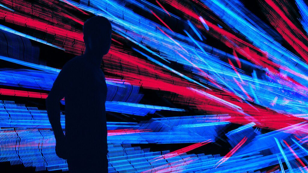 A man's silhouette in front of a barrage of red and blue lights to indicate the need to eliminate noise in vulnerability management