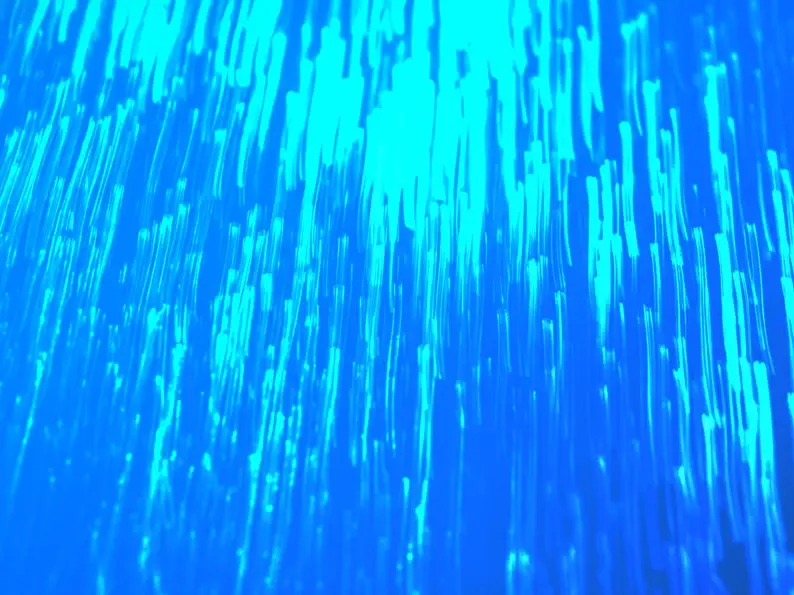 Abstract cyan and blue vertical streaks resembling falling light or data streams.