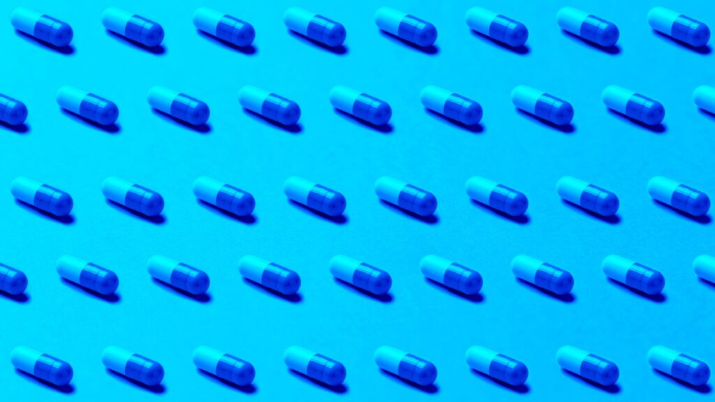 An image of pills in rows to illustrate the amount of intellectual property that pharmaceutical companies have and should protect with continuous pentesting.