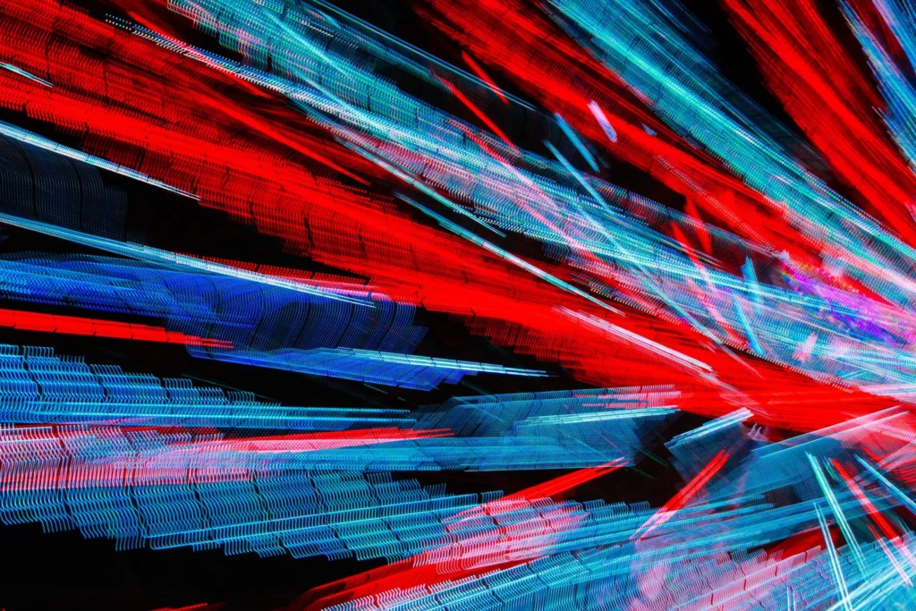 An abstract image featuring red, blue and black streaks of color suggesting sparks and movement.
